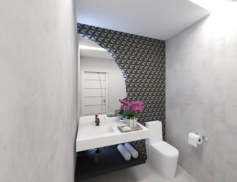 Clínica Coluna Saudável — Lavabo com revestimento geométrico e espelho orgânico.